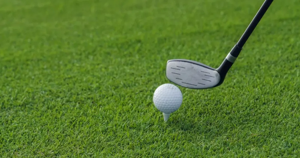 Golf club ready to strike ball on tee at Harbour Town, illustrating 2026 RBC Heritage golf tournament coverage and tips.