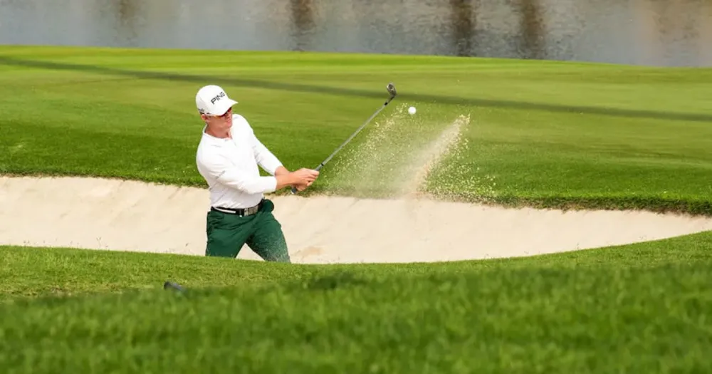 Matthew Fitzpatrick hitting a sand shot during the RBC Heritage 2026 third round on a sunny golf course.